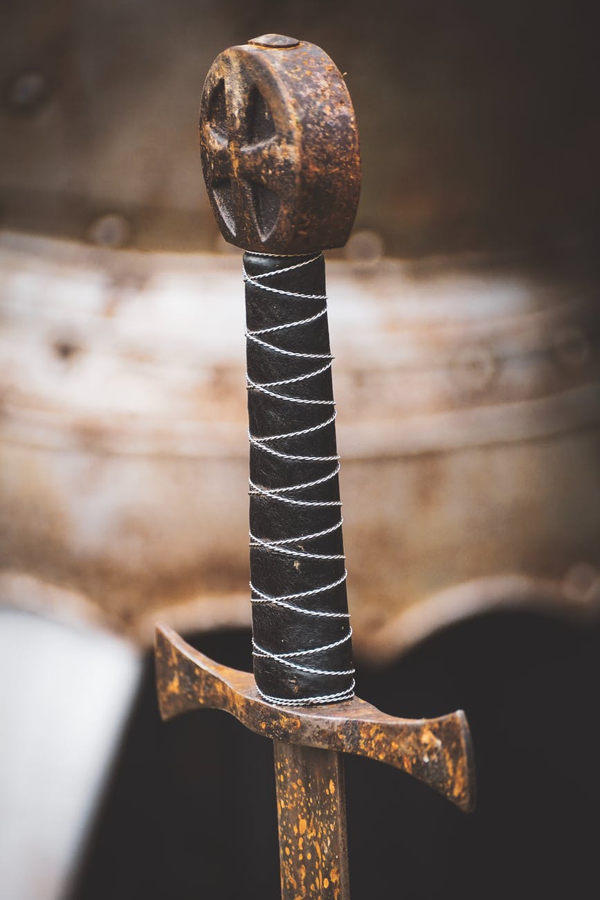 closeup photo of black hilt and brown sword